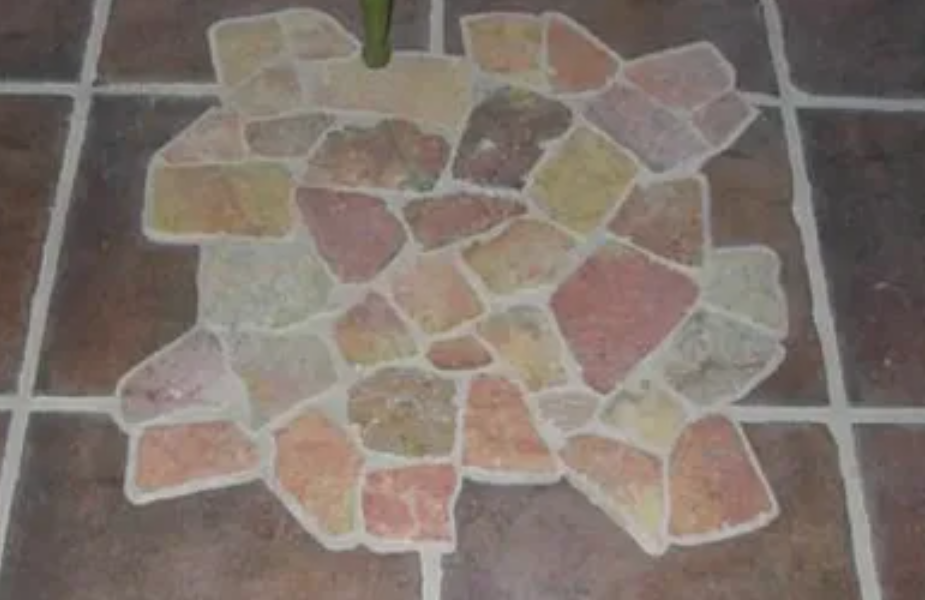 workers laying mosaic tile floor